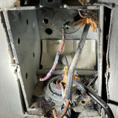 Damaged Electrical Box With Exposed Wires And Burnt Insulation