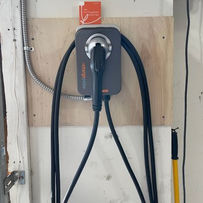 Ev Charging Station With Cables And Plaque In Garage Setup
