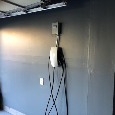 Garage Wall With Electric Car Charger And Cable In View