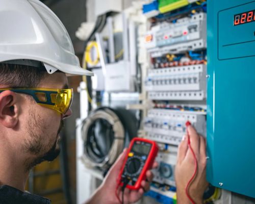 Electrician Testing Circuit With Multimeter In Industrial Setting Odenton Md